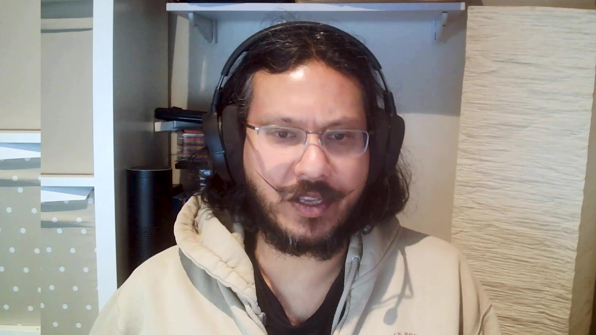 Man with glasses sits in front of computer
