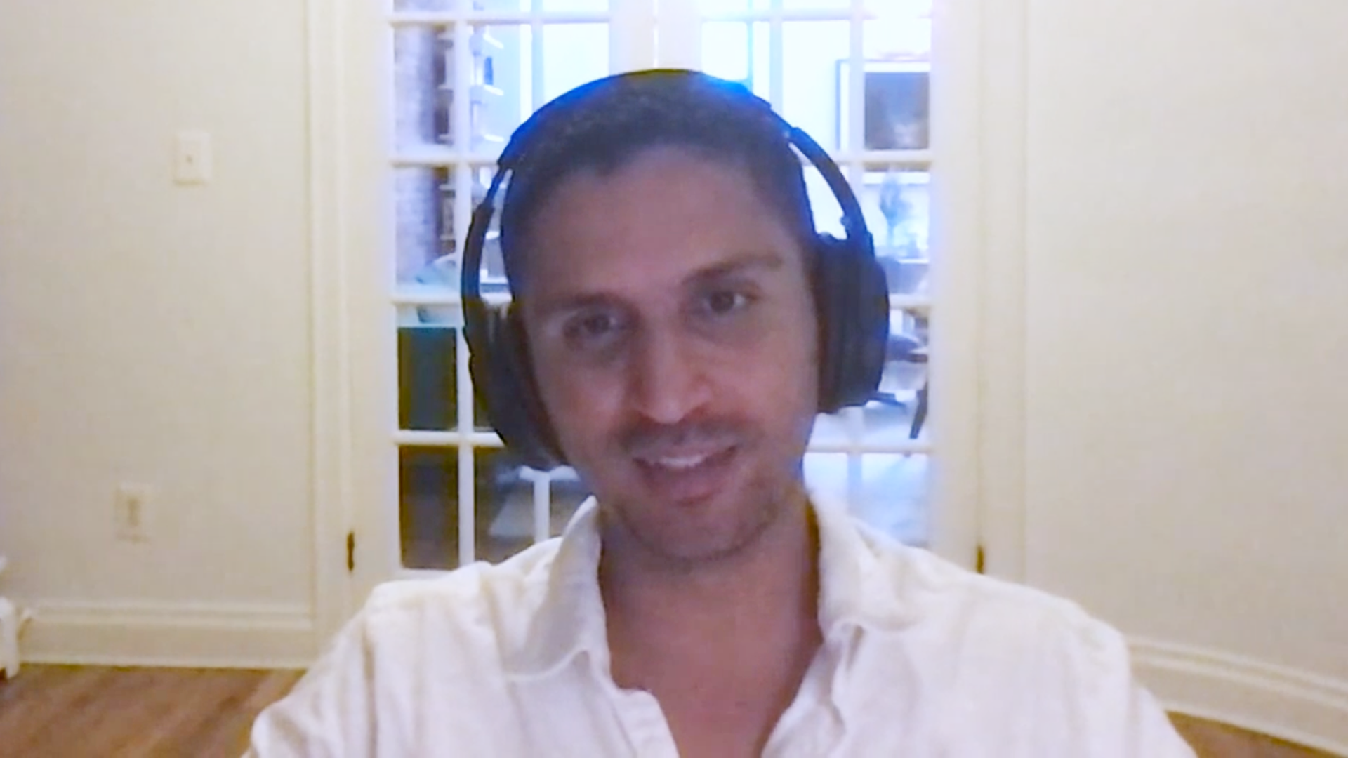 Man smiles in front of computer