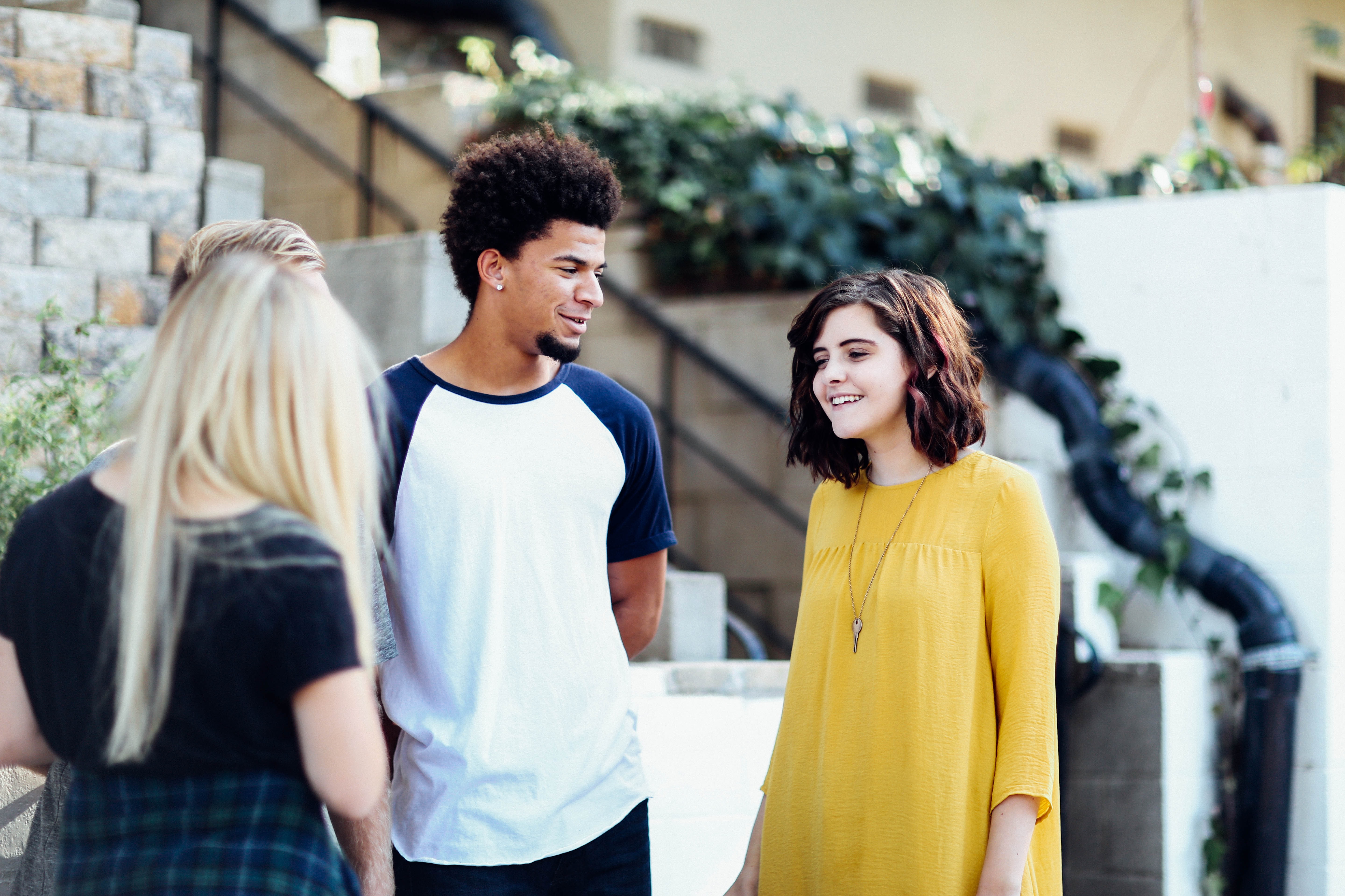 Three young people standing outside a building