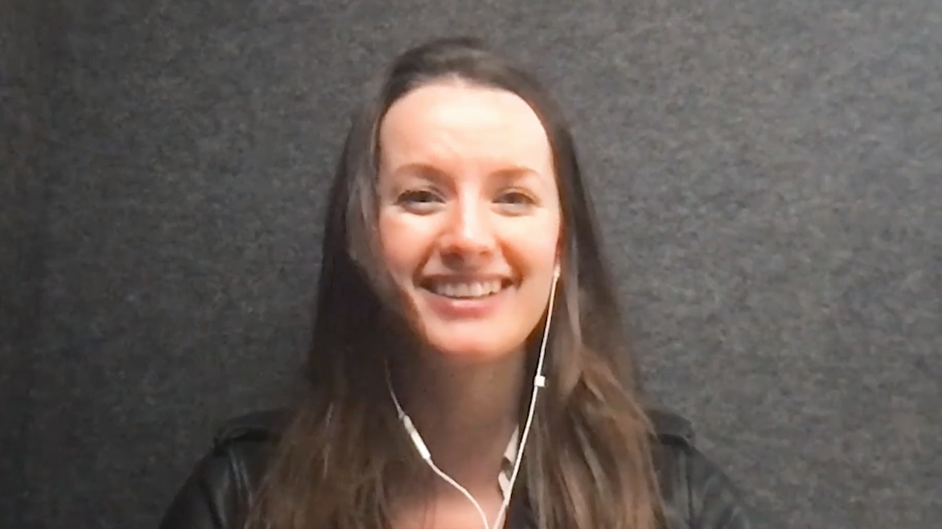 Woman smiles in front of computer