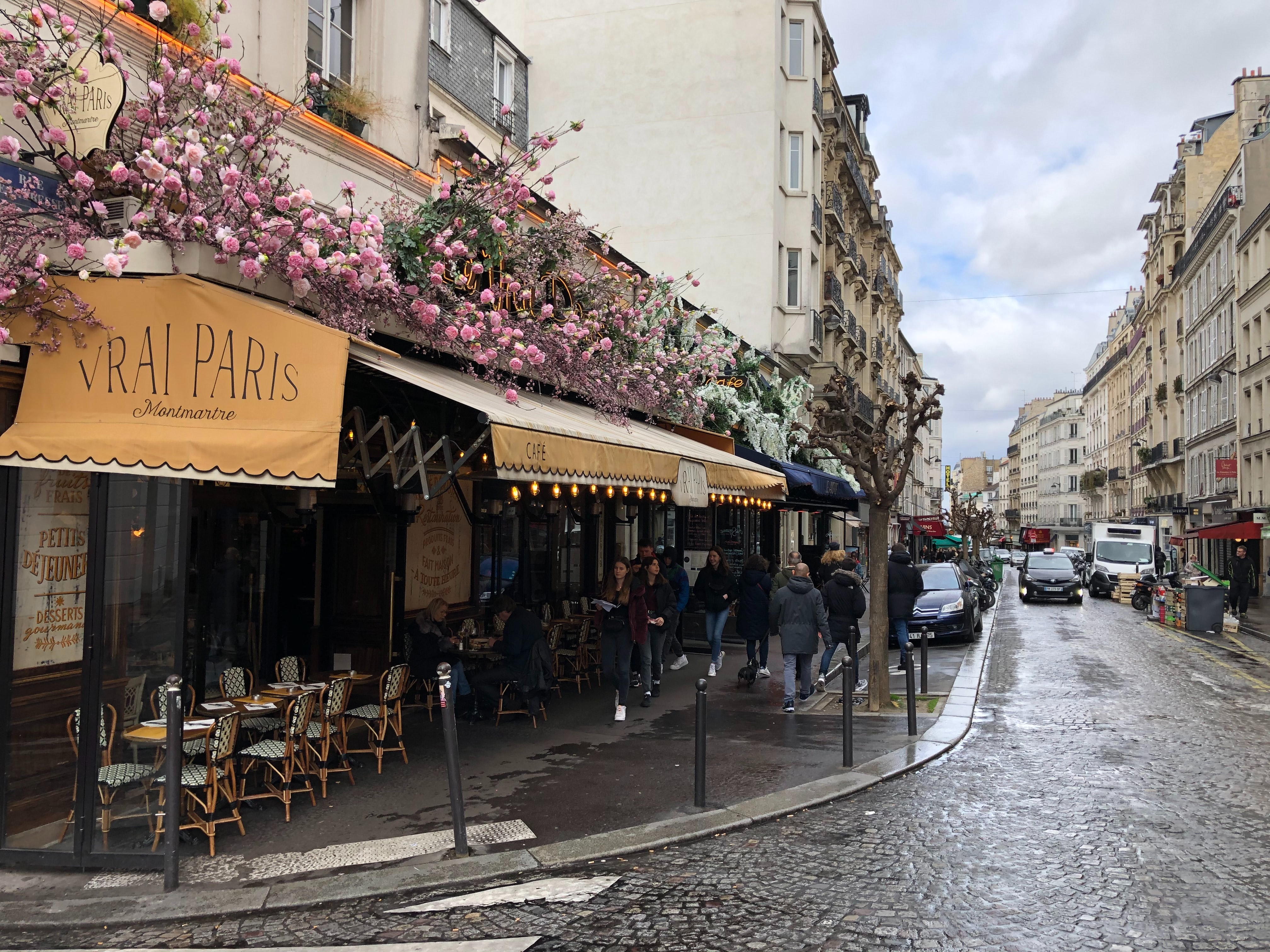 A street outside a cafe called 'Vrais Paris'