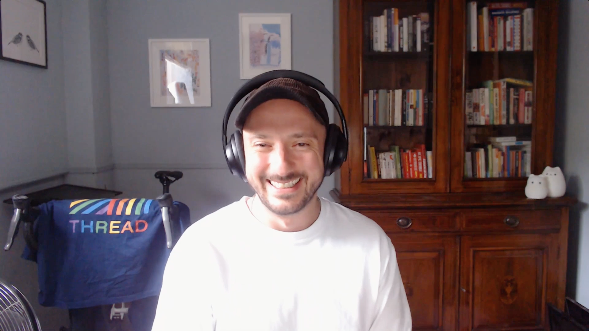 Man smiles sitting in front of a computer