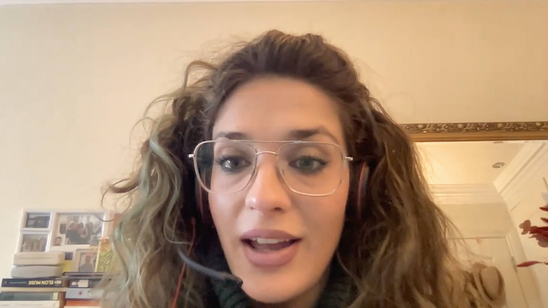 Woman with glasses sits in front of computer