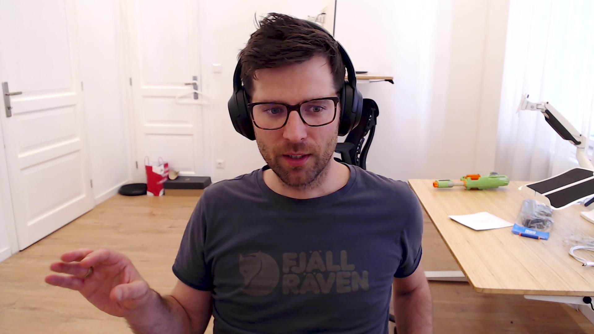Man with glasses sits at computer