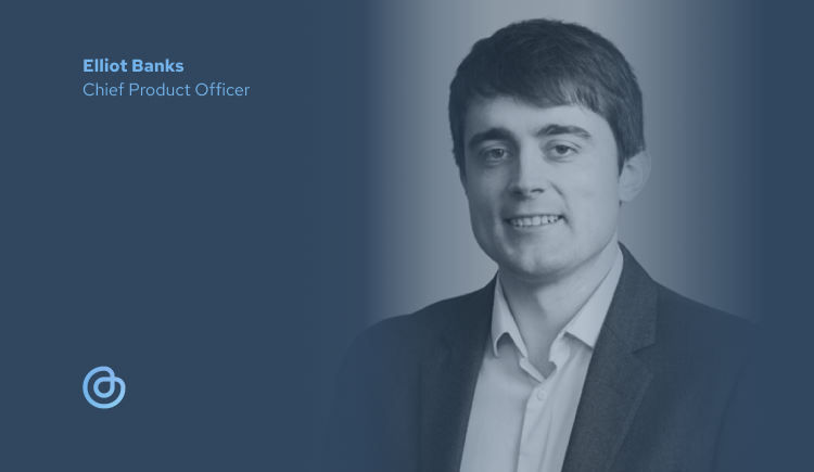 Elliot Banks - Chief Product Officer. A man in a shirt and jacket smiles towards the camera.