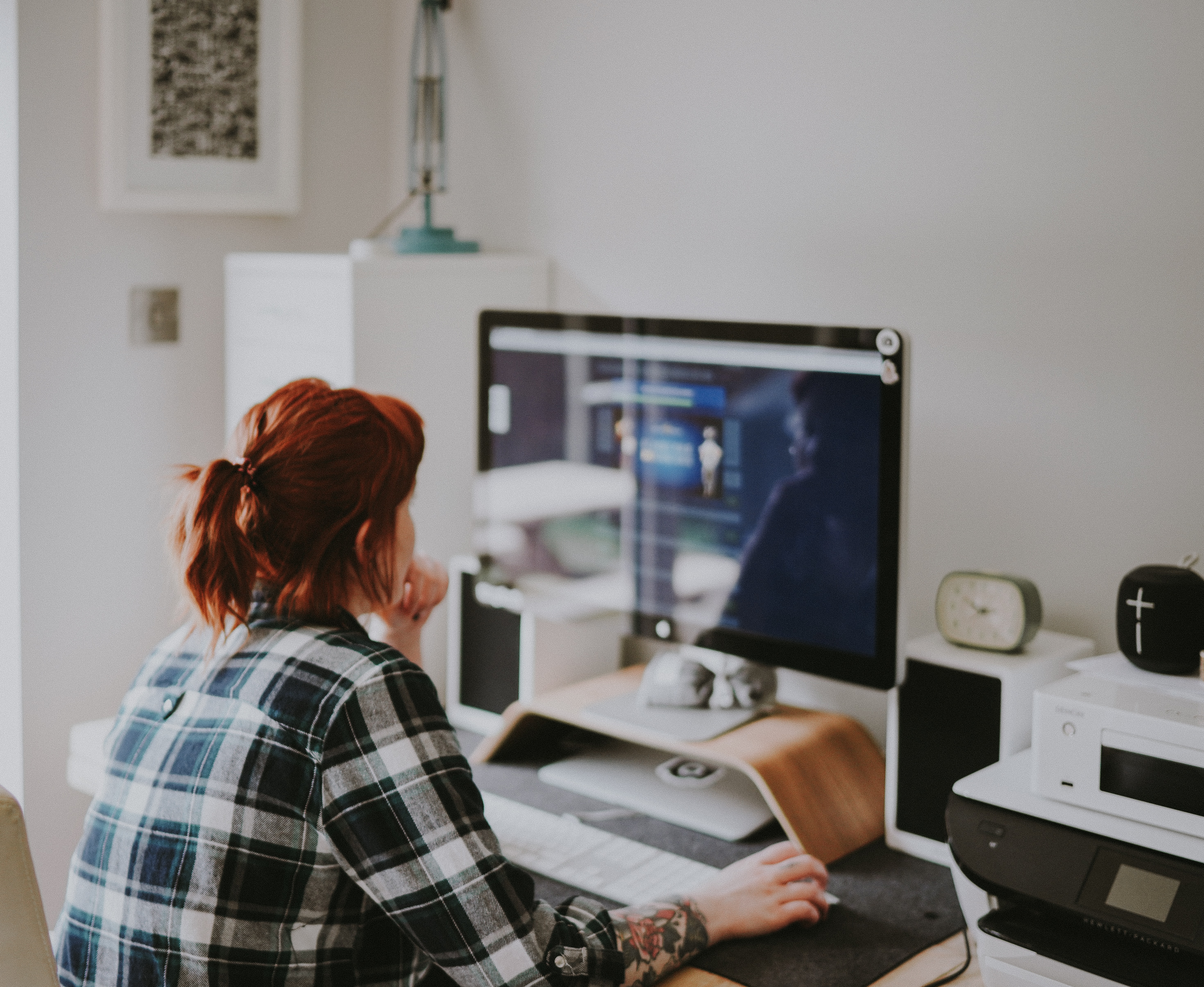 A woman sitting at her computer screen in her home office