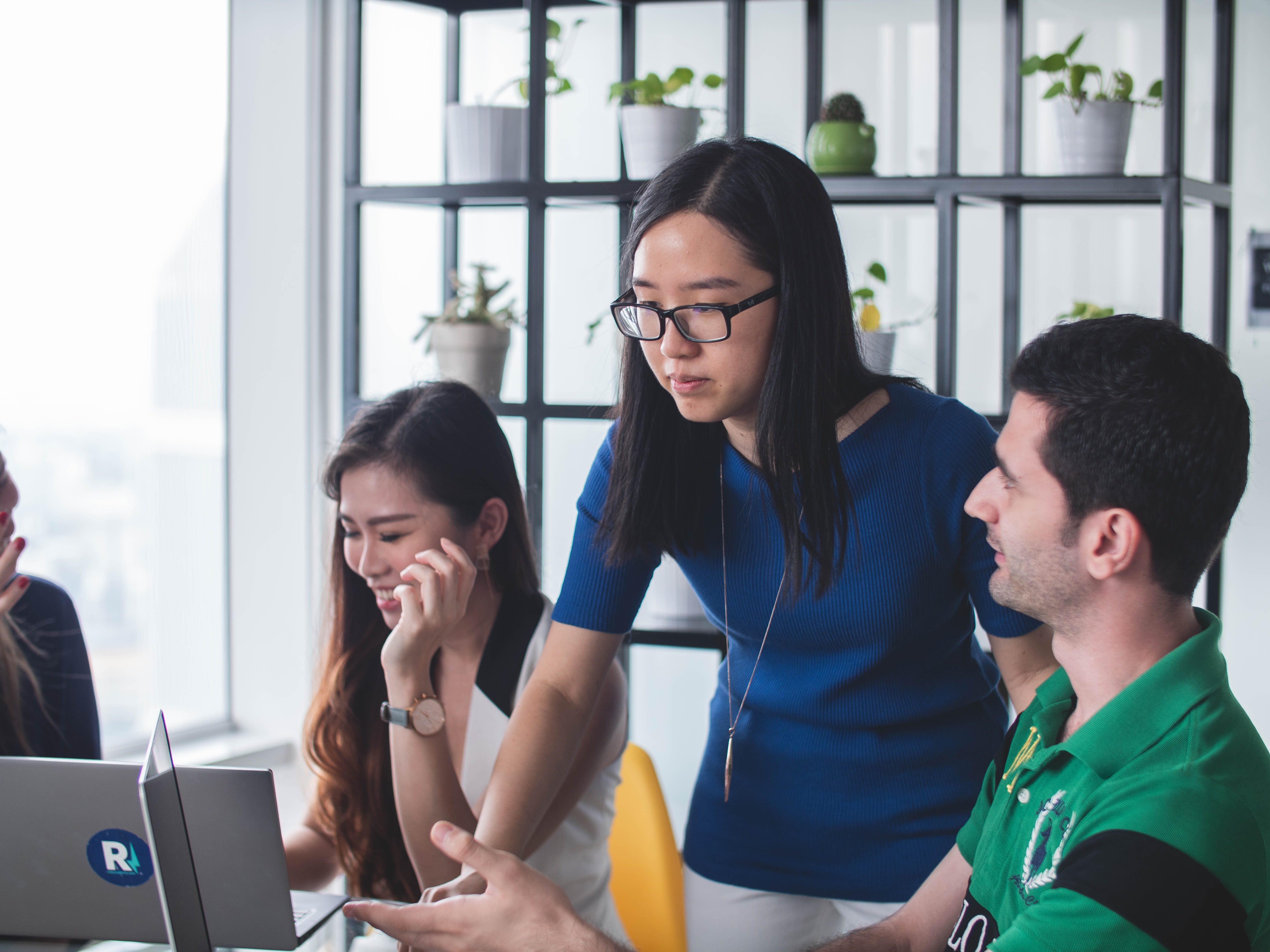 Cover of Three people around a desk looking at laptops article