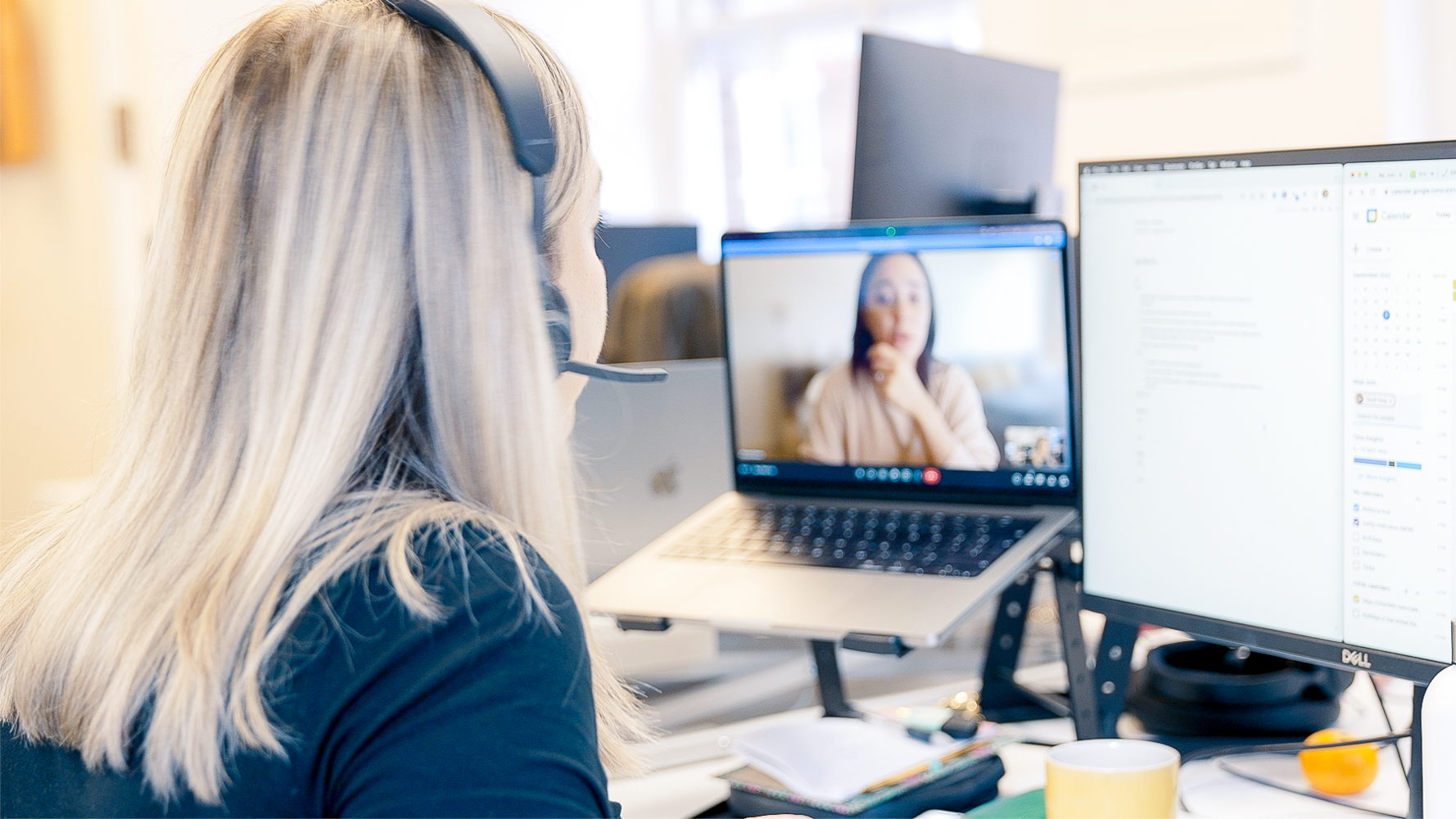 Cover of A woman sitting at a desk in an office speaking to someone else via video conference article