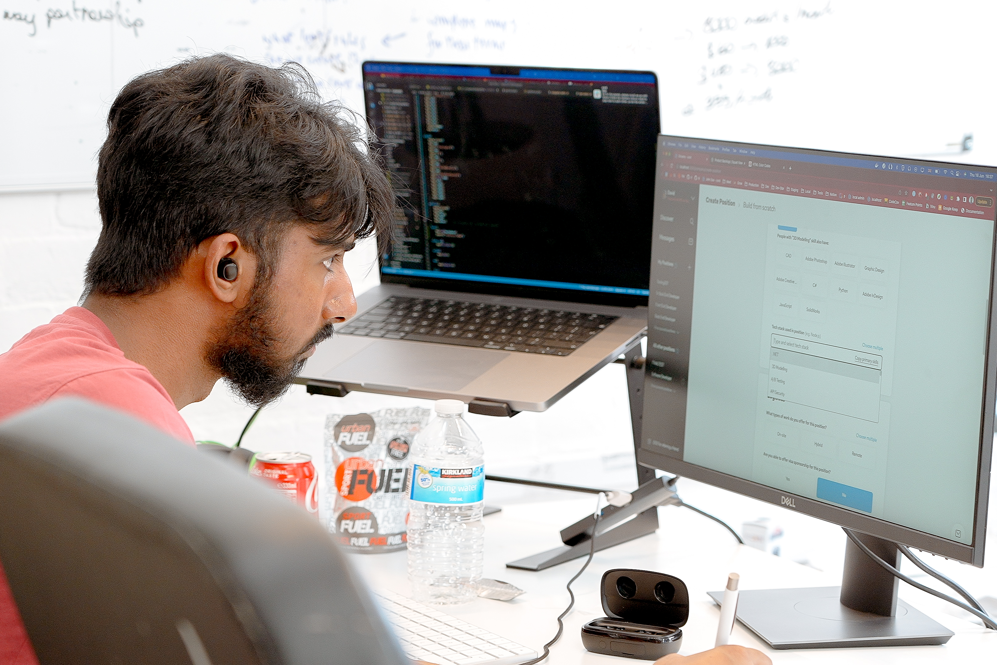 Cover of A man in a pink t-shirt looks focusedly at a computer monitor article