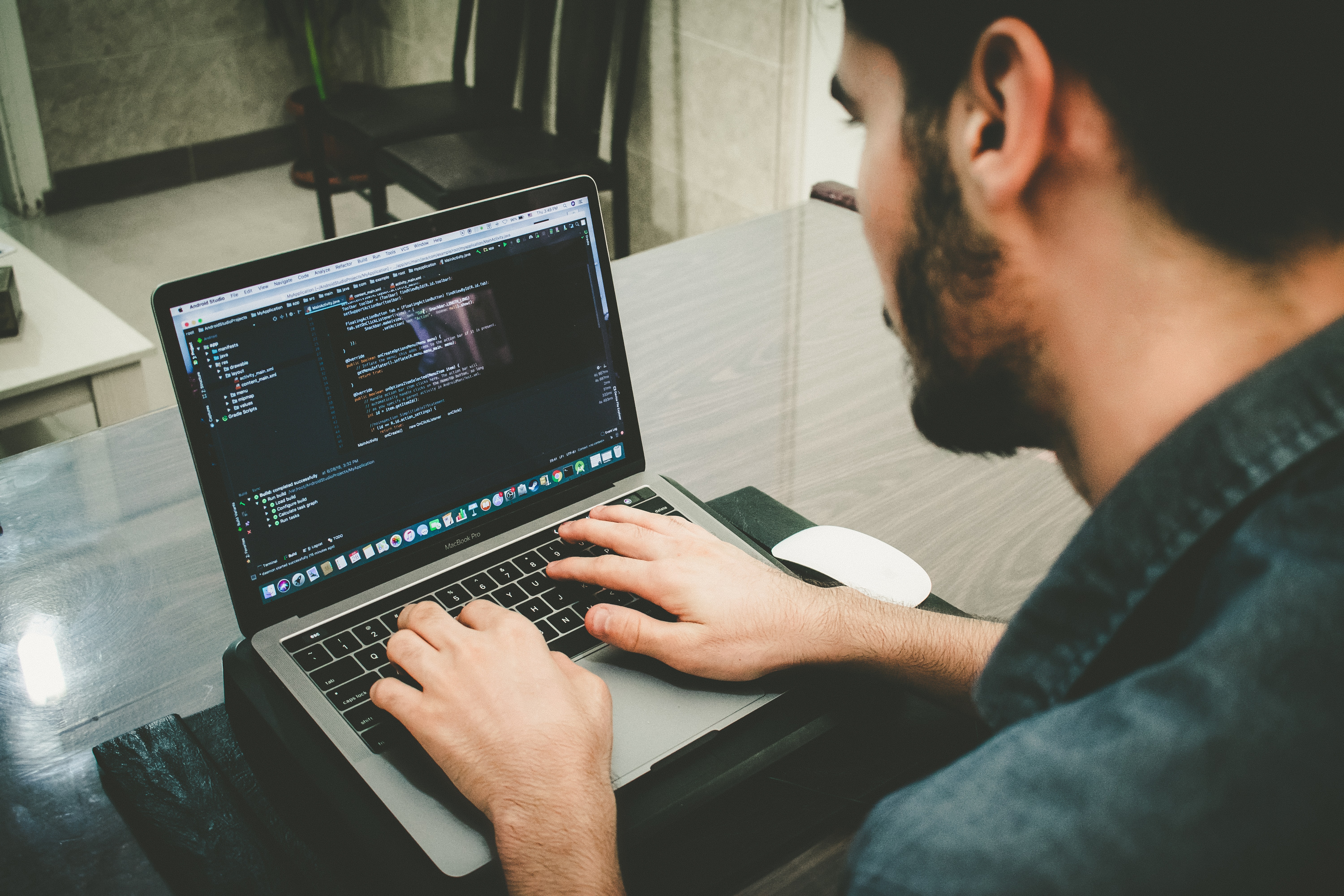 Man working on code on a laptop