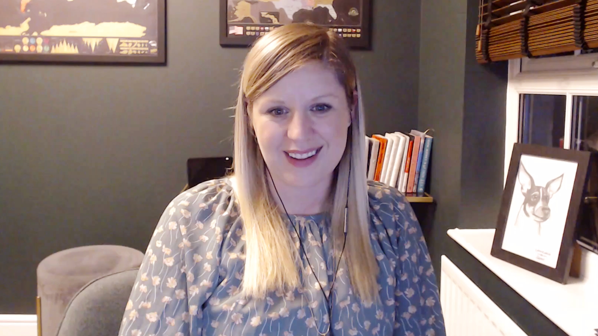 Woman smiles sitting in front of computer