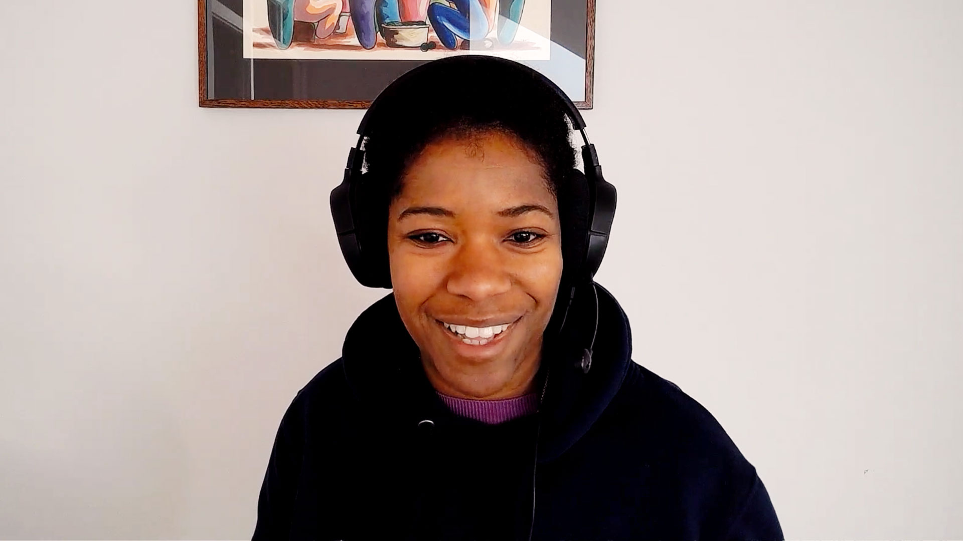 Smiling woman sits in front of computer