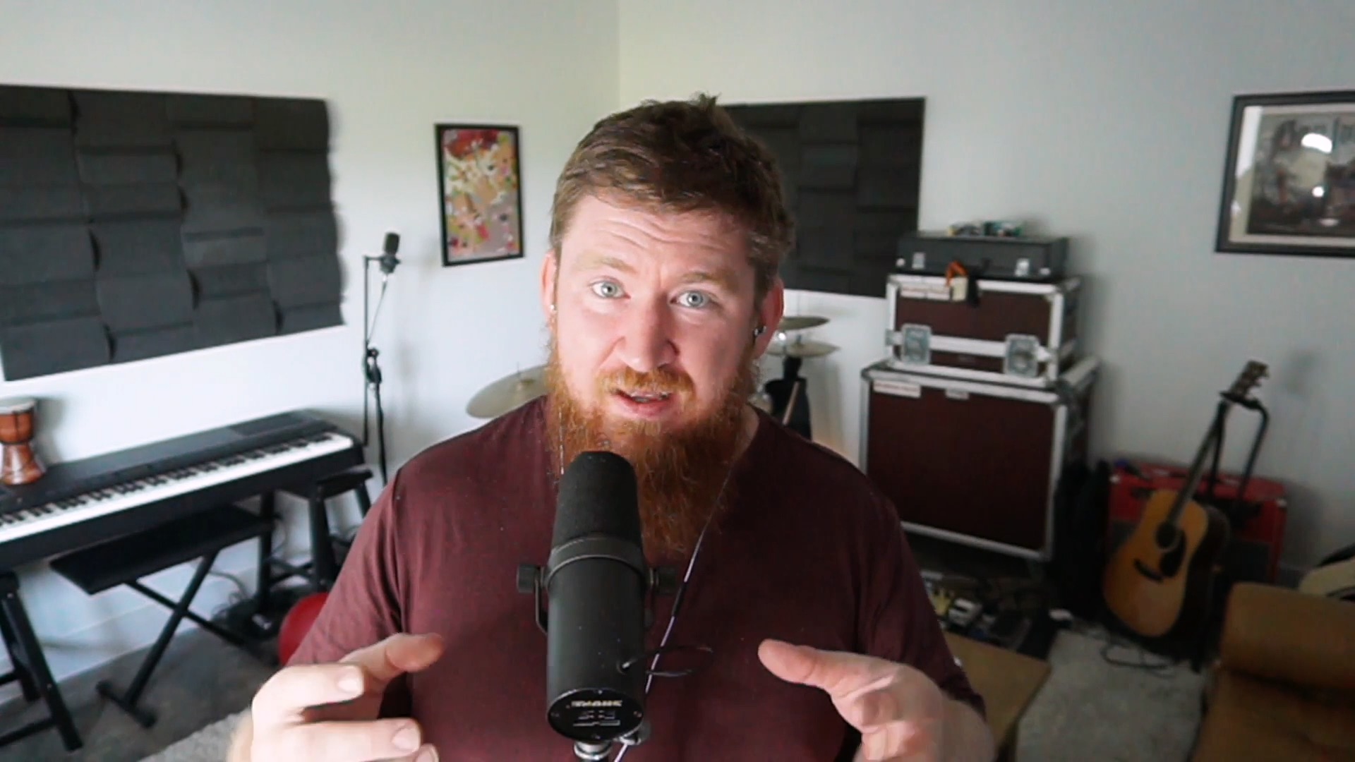 man with beard stands in front of computer