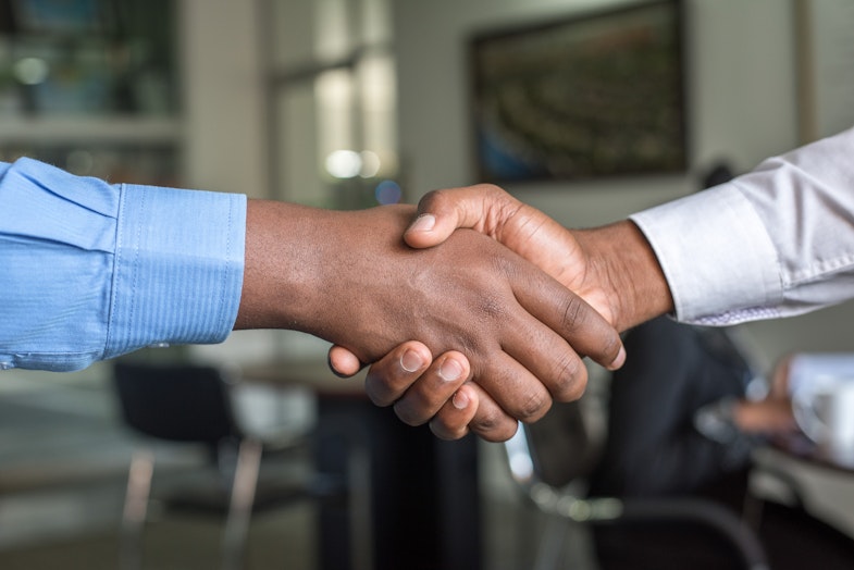 Two people shaking hands, accepting job offer