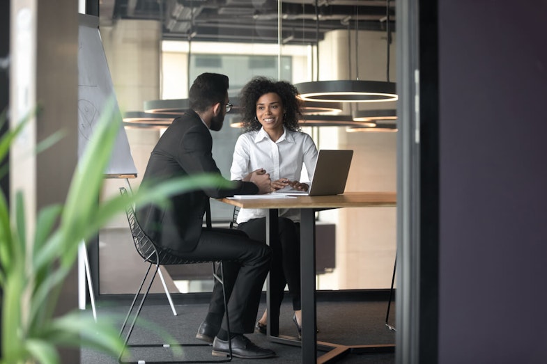 two people sitting and talking