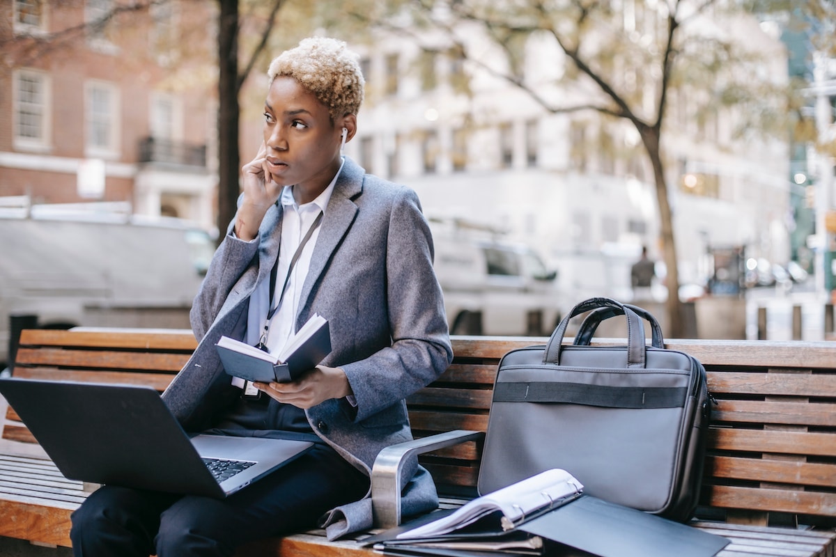 Business person working in park, private equity trends 2023