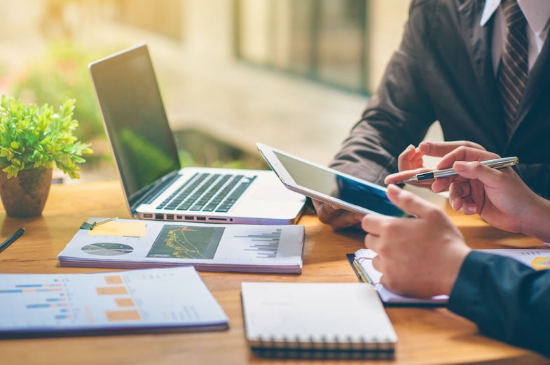two people analyzing data on devices