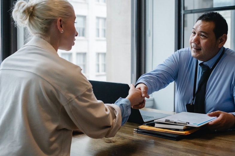 Employer hiring a new employee, shaking hands