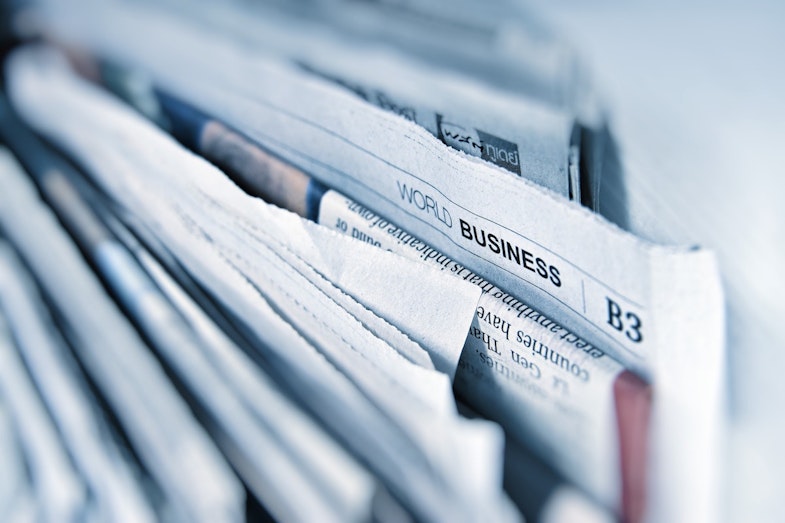 newspaper with business section