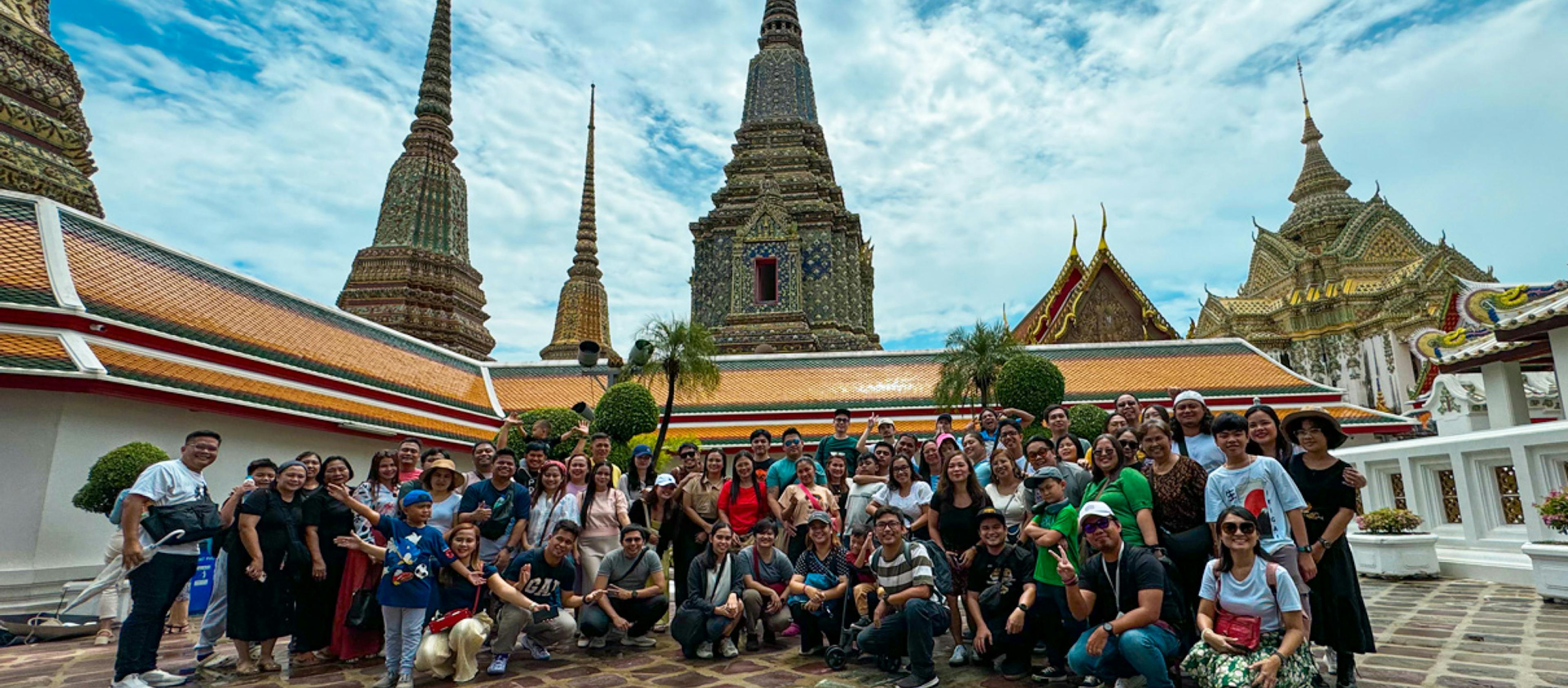 A group picture of Arcanys employees in front of a temple in Thailand