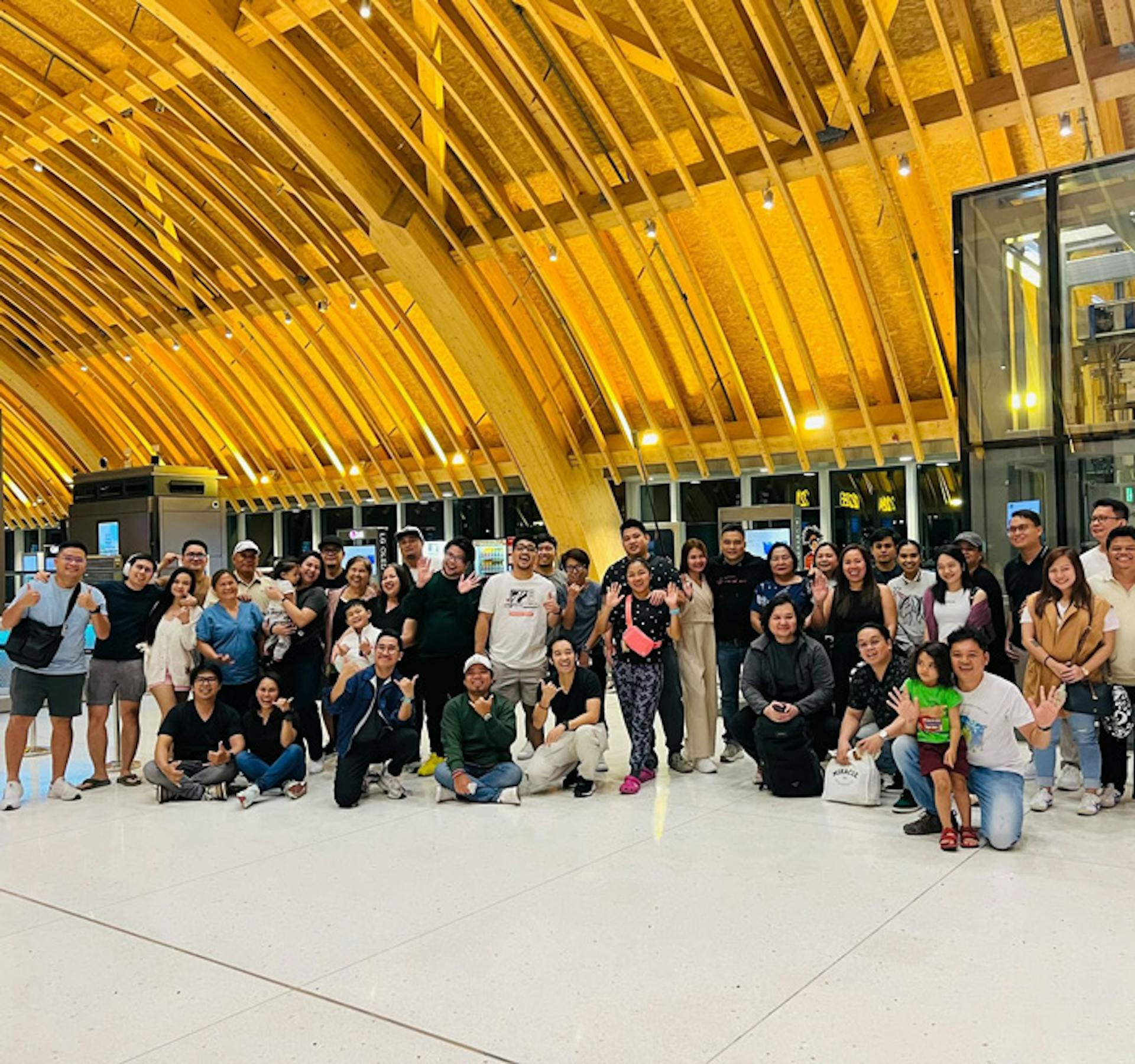 a group of people posing in the airport