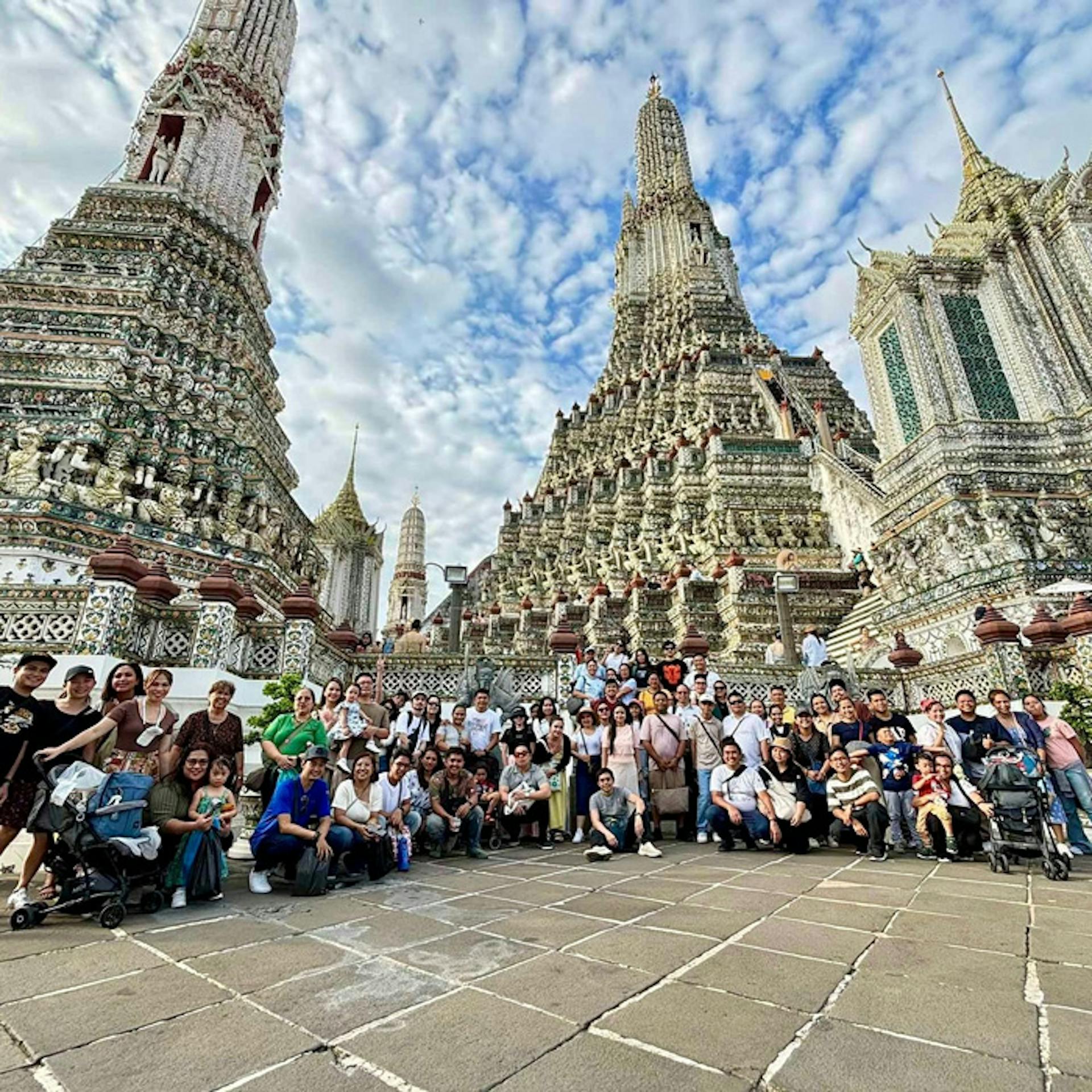 group of people posing in front of a temple