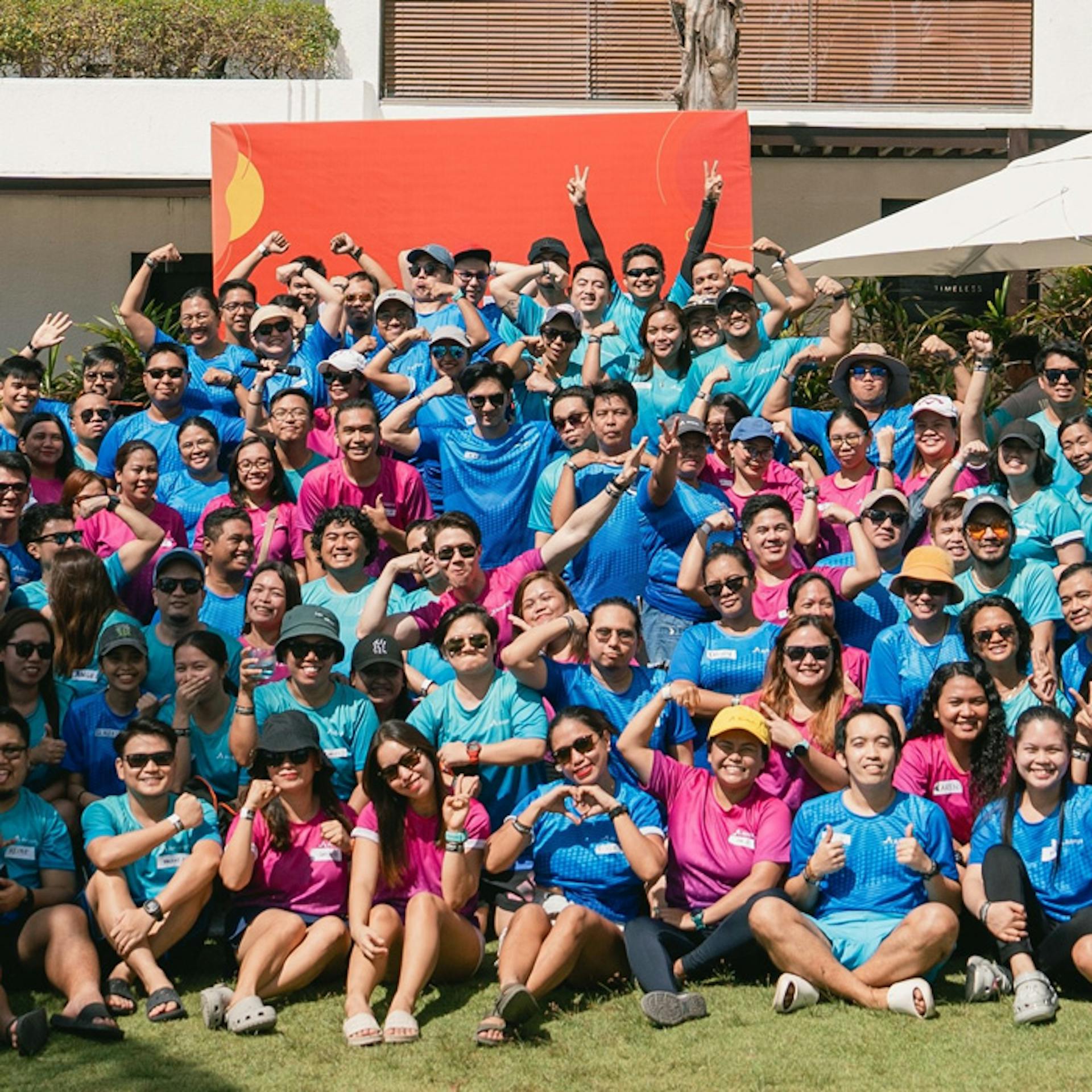 people posing with blue and violet shirts on 