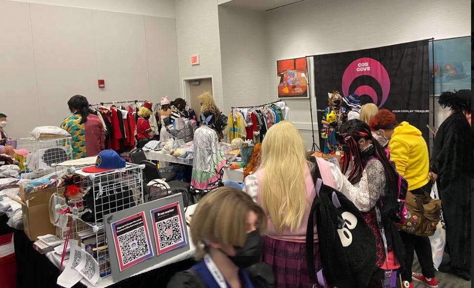 cosplayer browsing items at in person coscove cosplay marketplace 