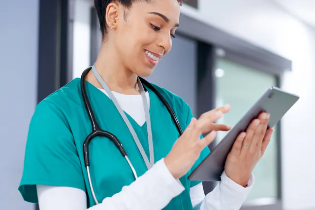 A nurse working on her tablet