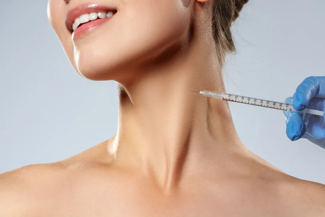 Female receiving aesthetic treatment to her neck area