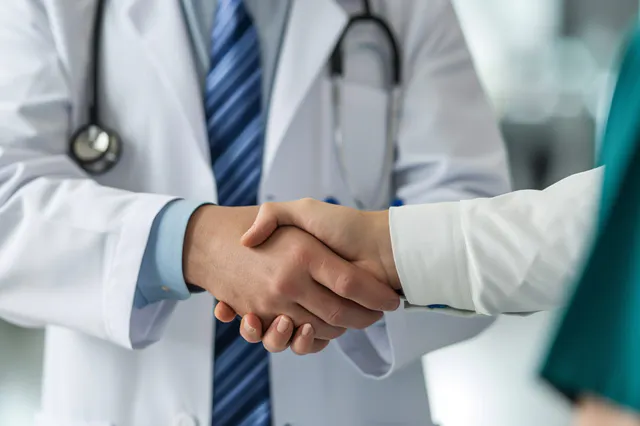 Doctor shaking hands with a nurse