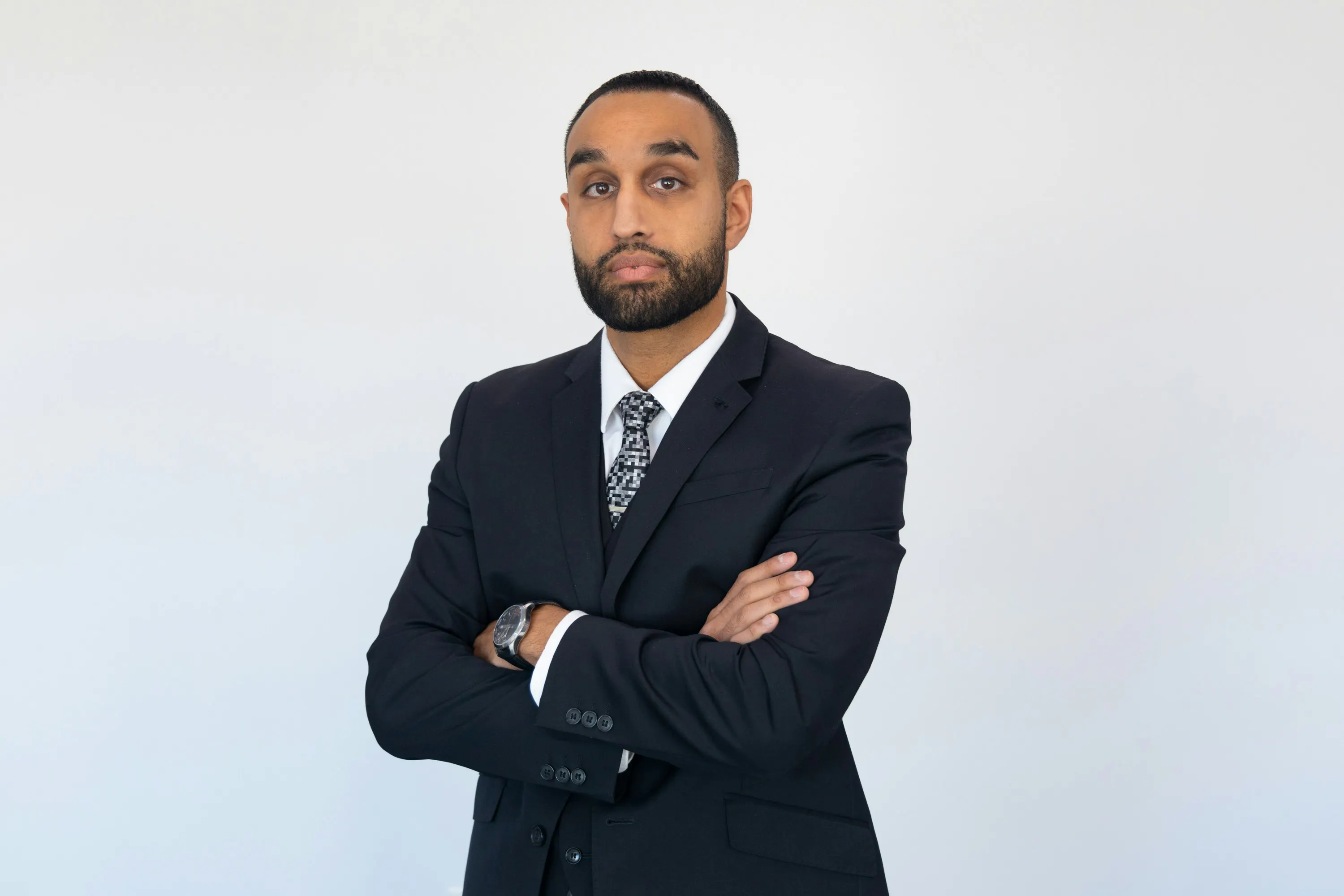 Man in suit and tie with his arms folded