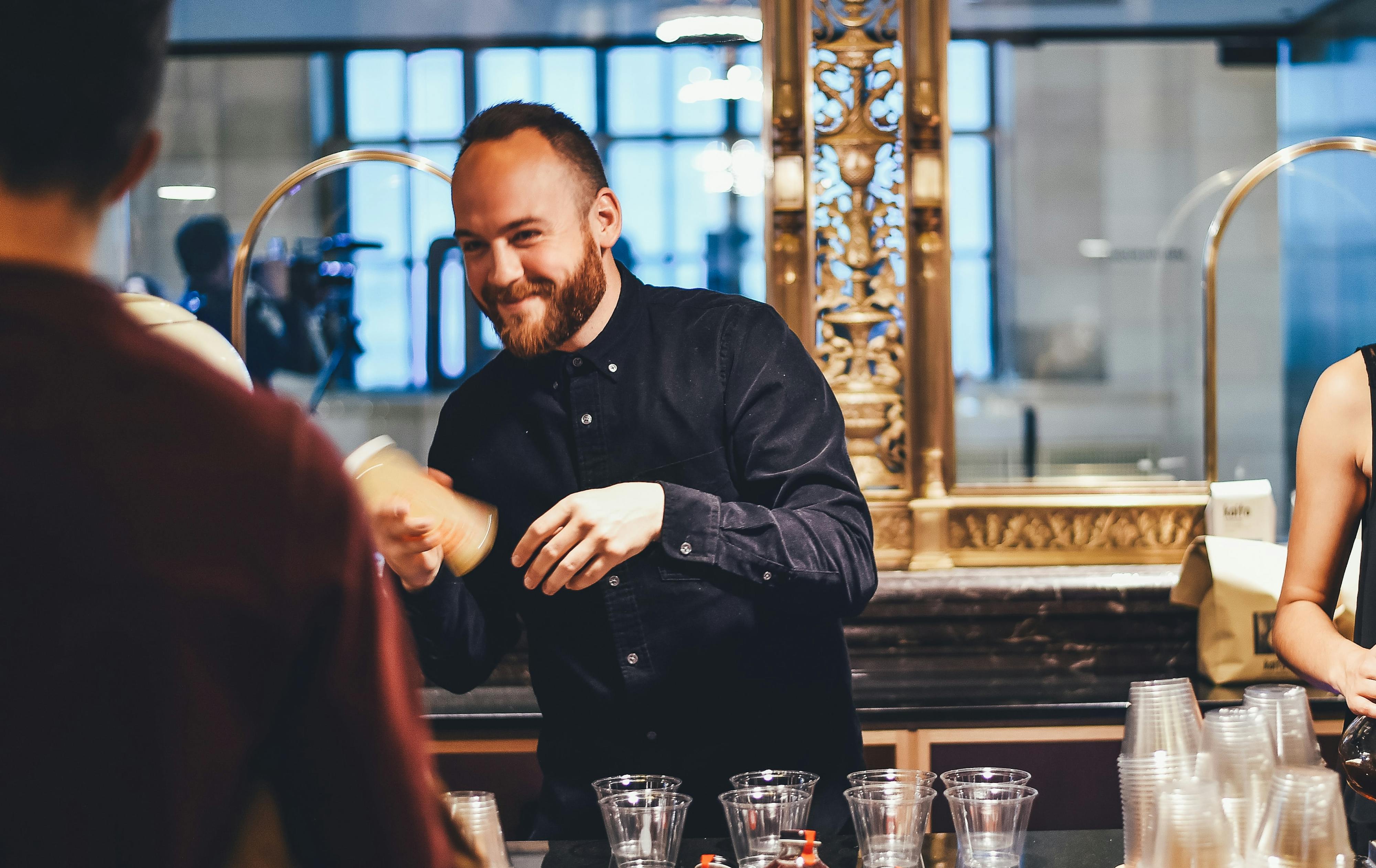 Small business owner making drinks behind a counter