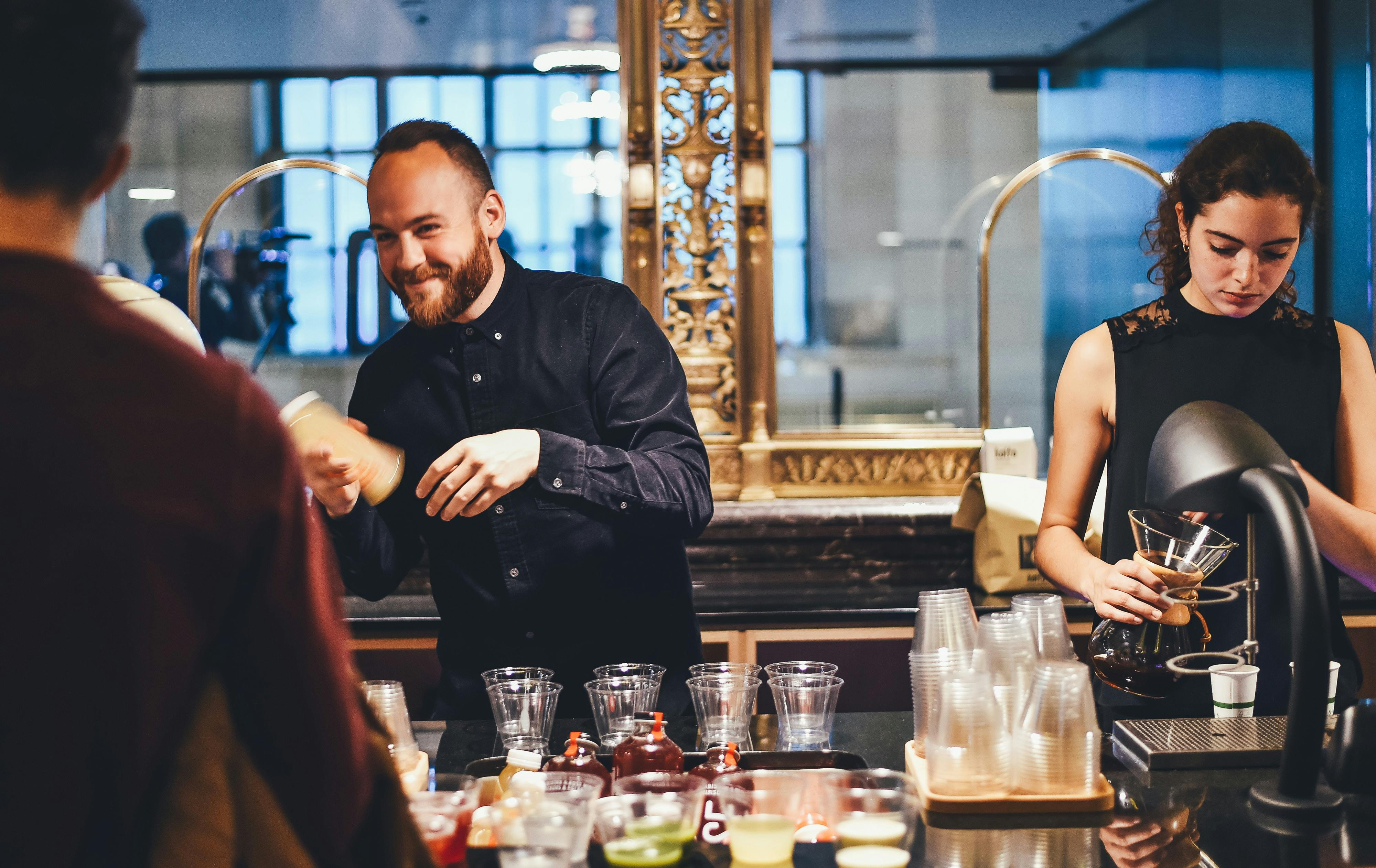 Small business owner making drinks behind a counter