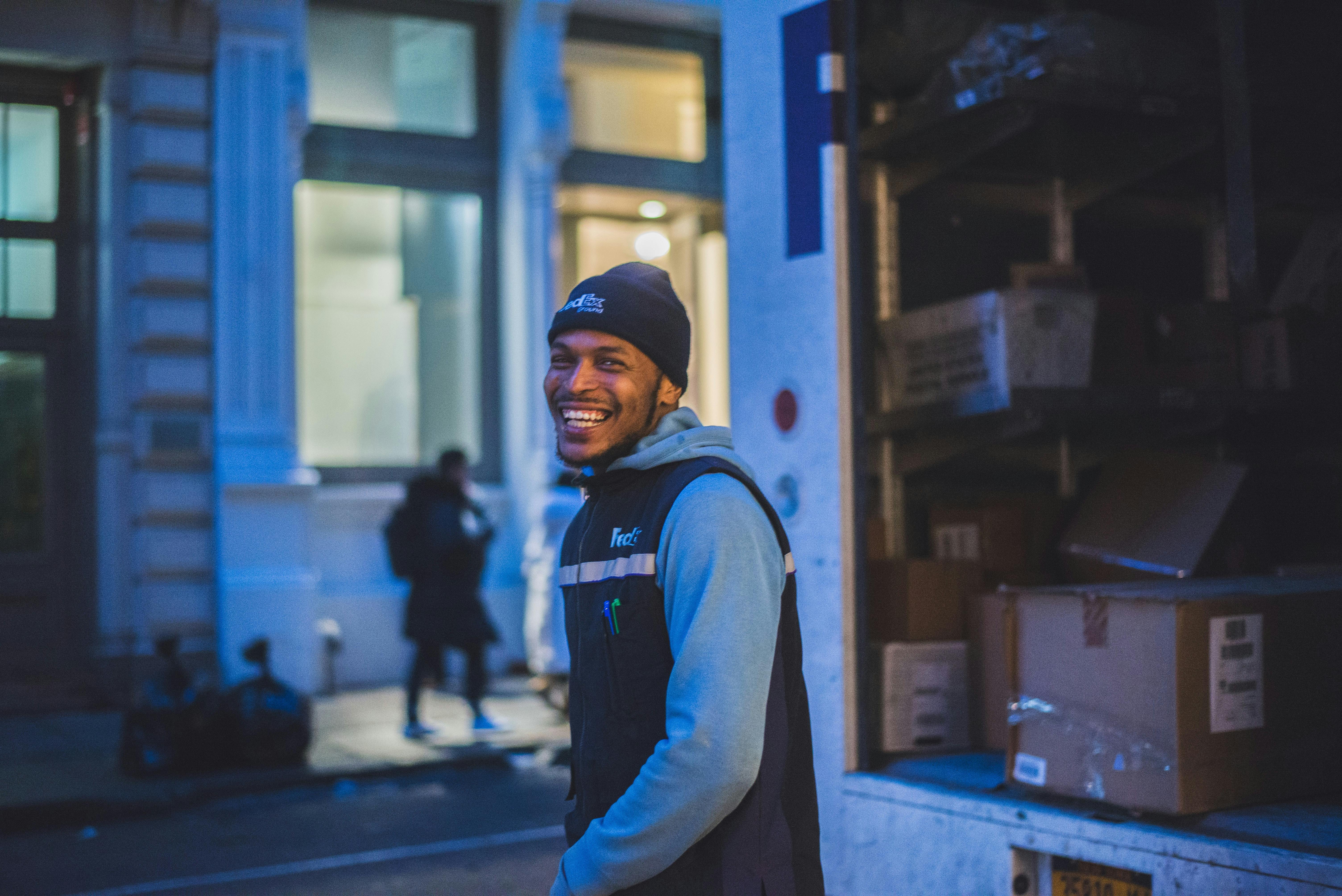 Delivery service person outside of their delivery truck