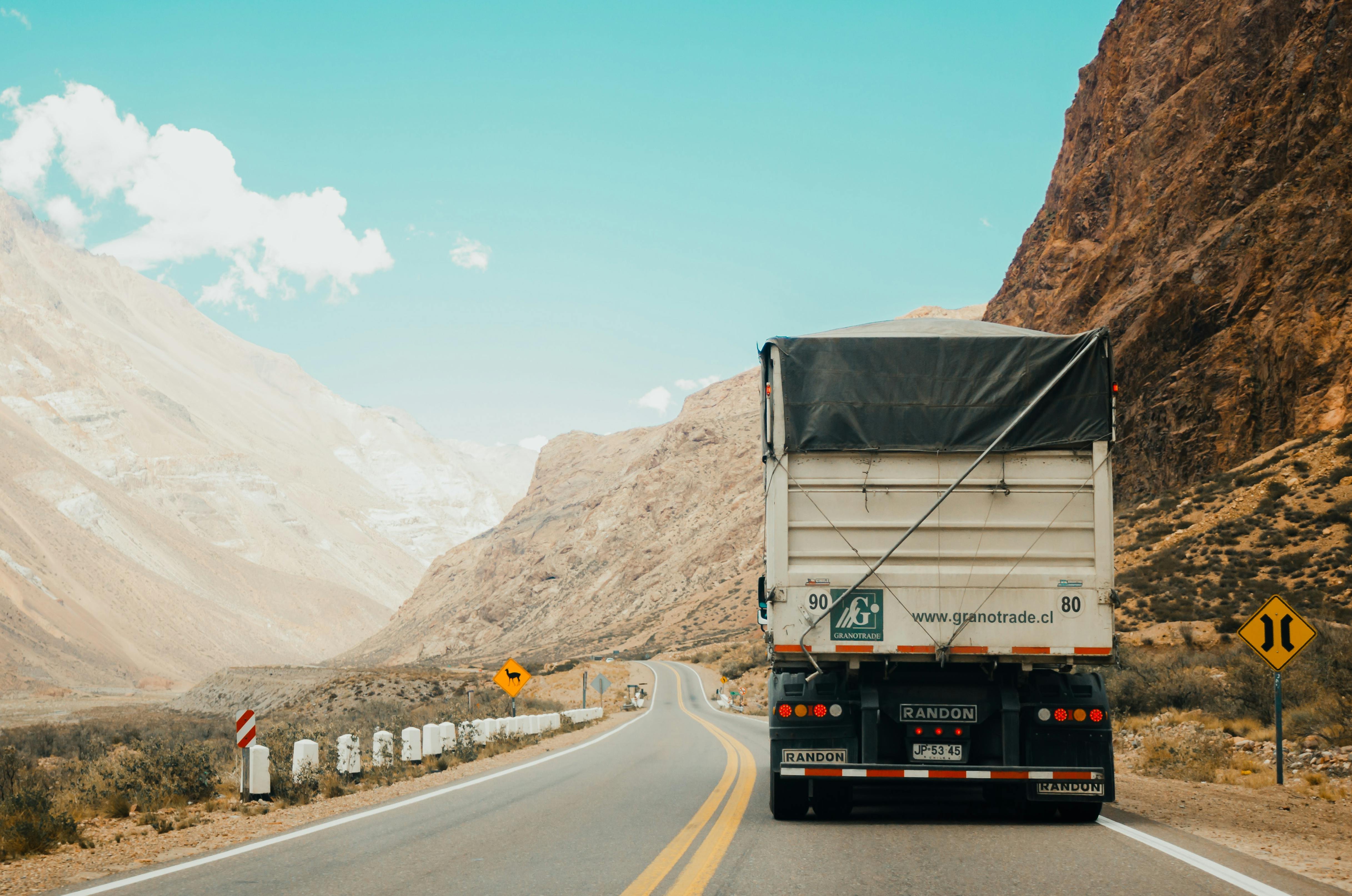 Semi truck driving through desert roads