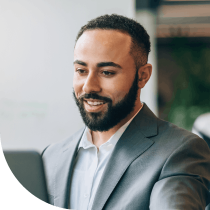 man in suit looking at computer