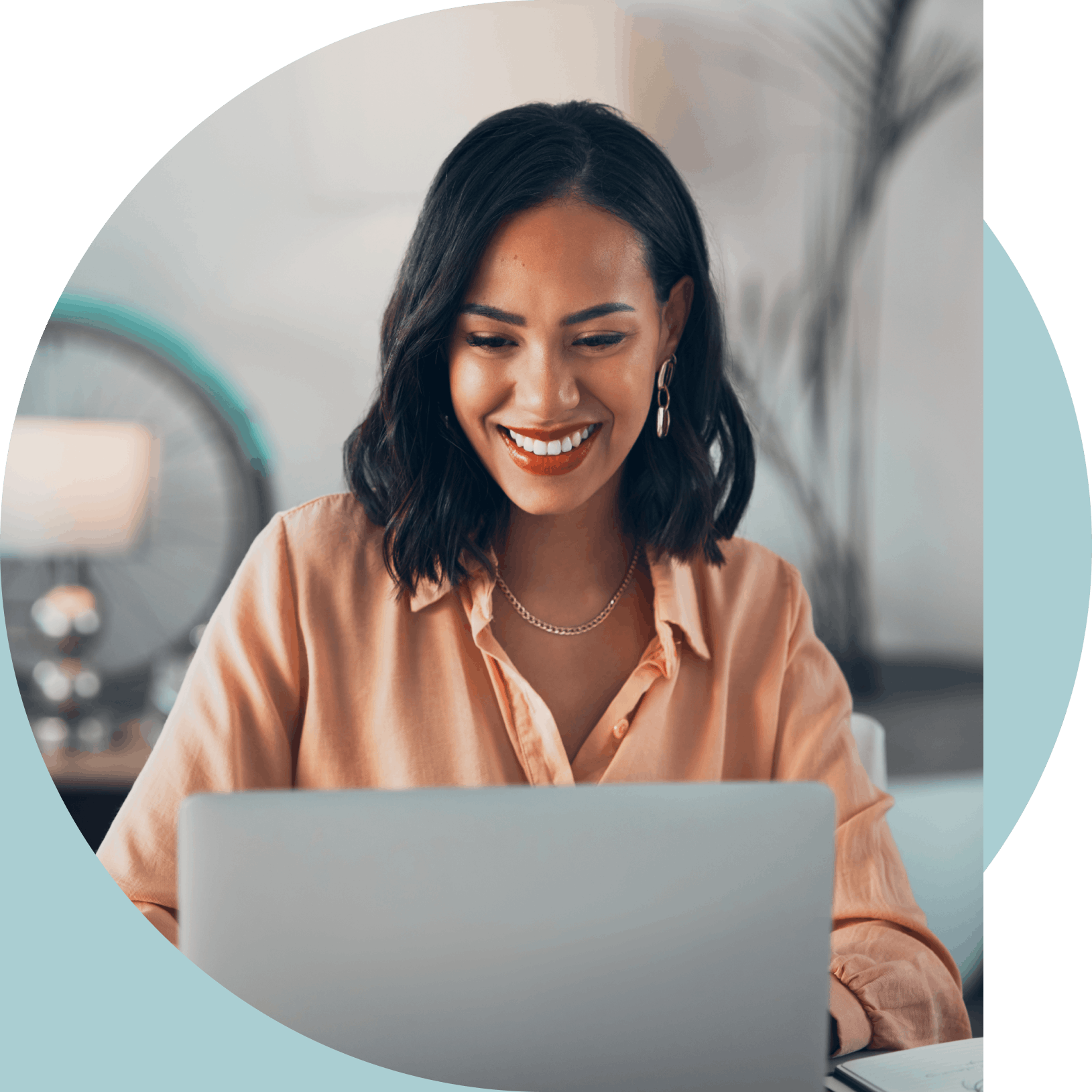 Woman smiling while working on her laptop