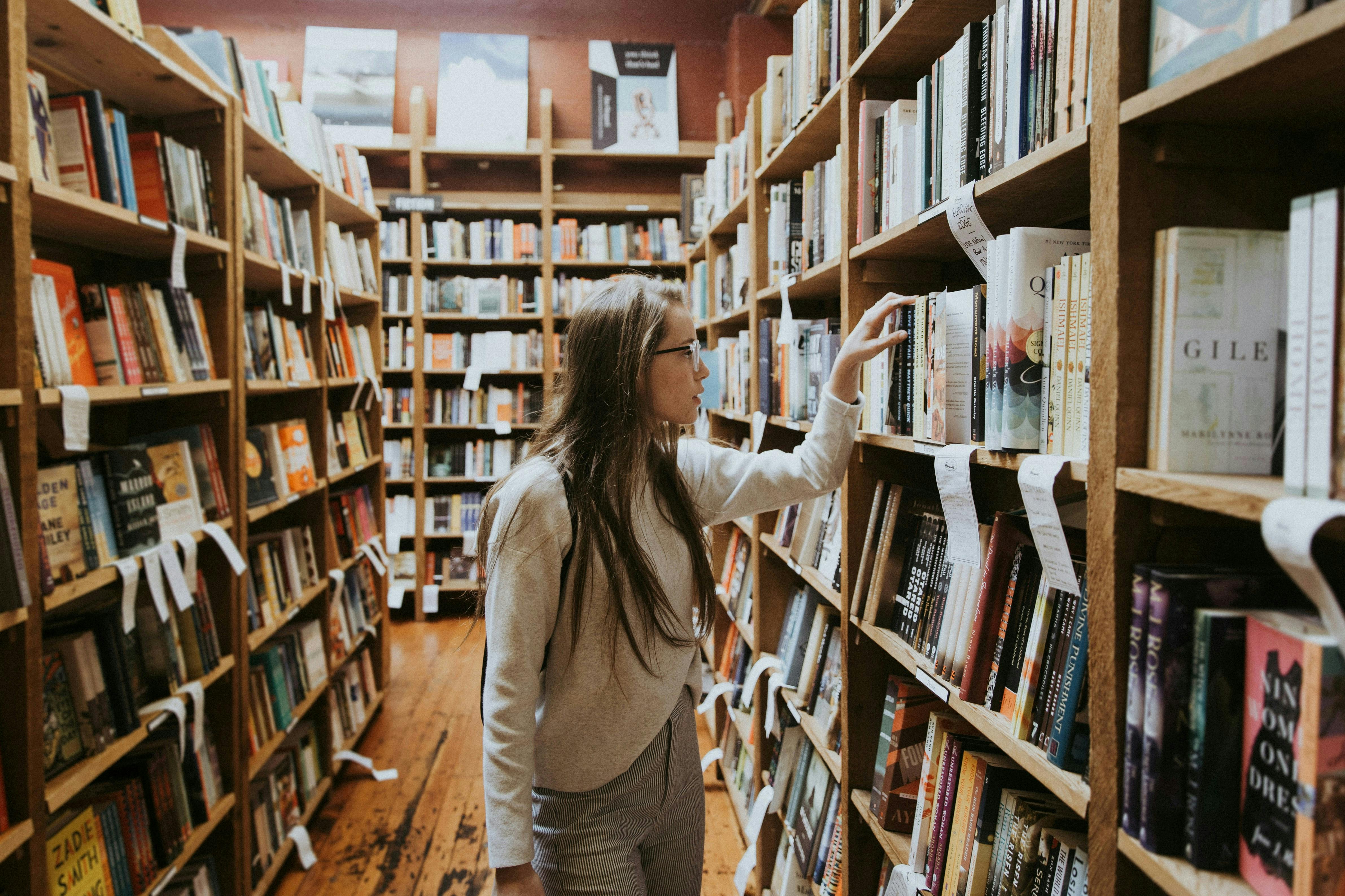 Woman looking at books in a library