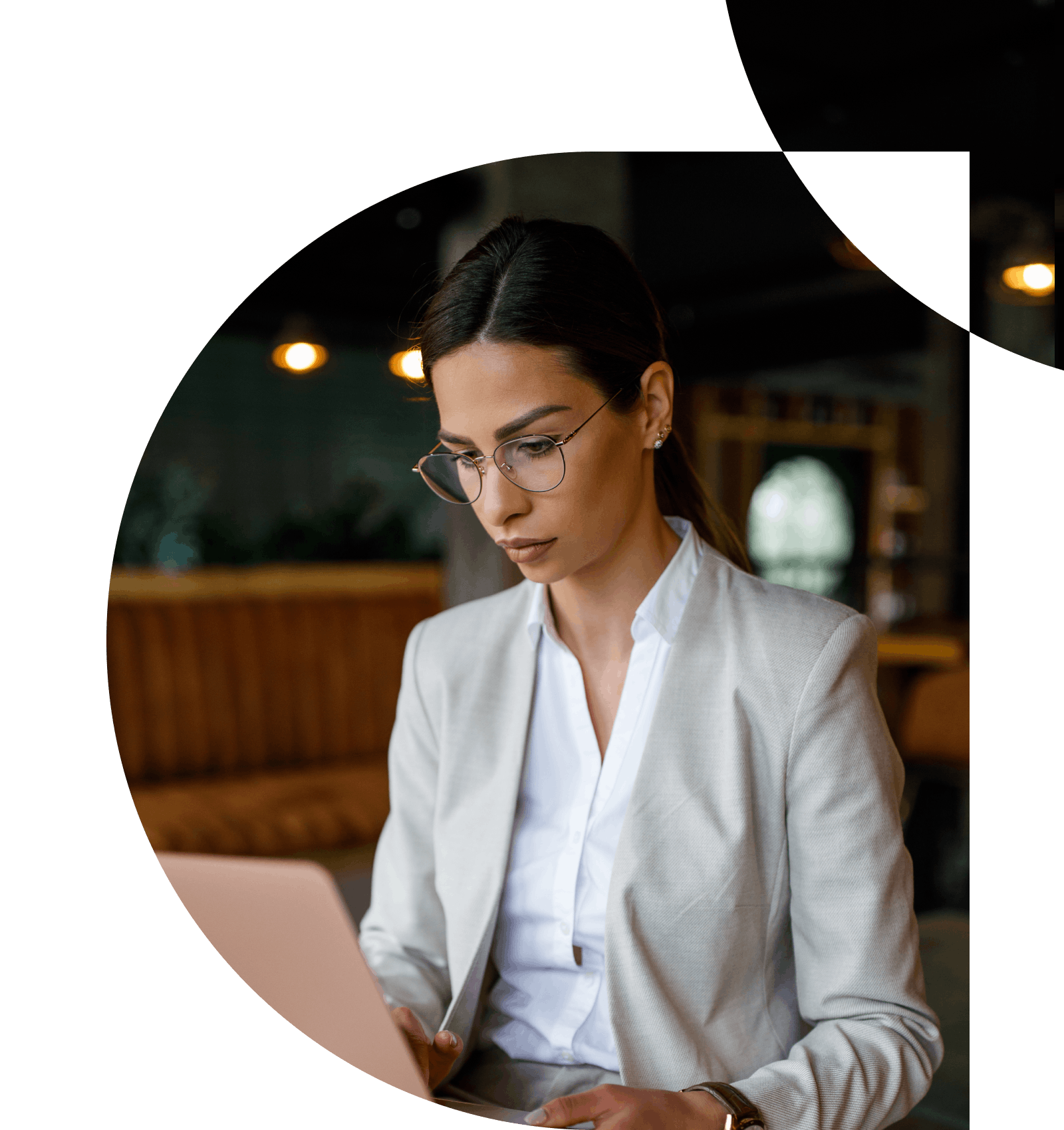 Woman with glasses working on her laptop