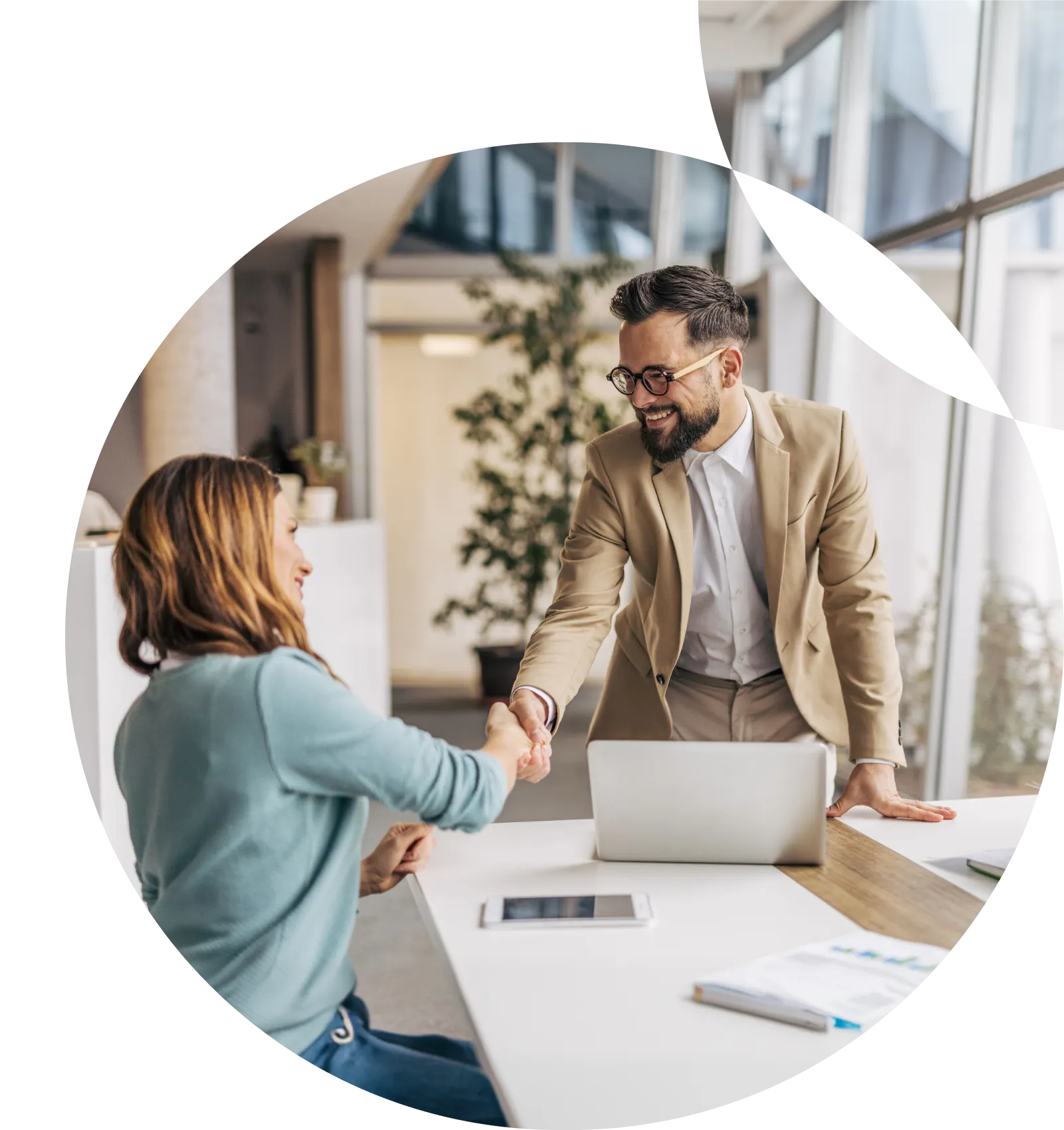 Man and woman shaking hands at a table