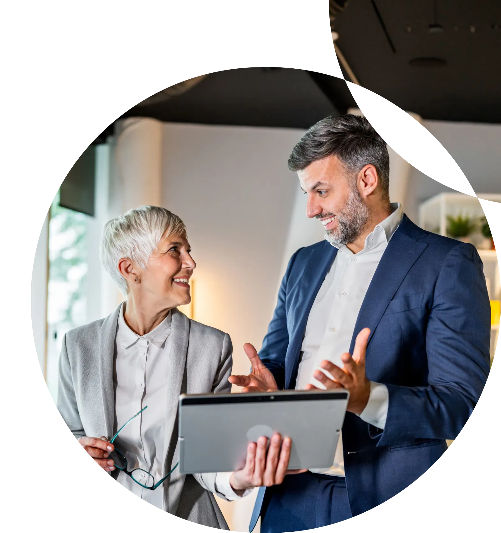 Man and woman looking at a tablet together and talking
