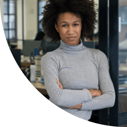 Small business owner with insurance stands confidently in the doorway of her business