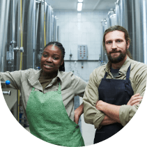 Two people in aprons in industrial space