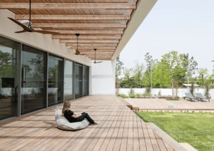 girl sitting under outdoor shading device