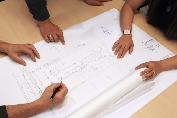 architects reviewing hospitality development real estate drawings 