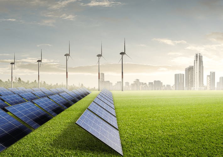 photovoltaic (PV) panels, wind turbines, city scape in disctance