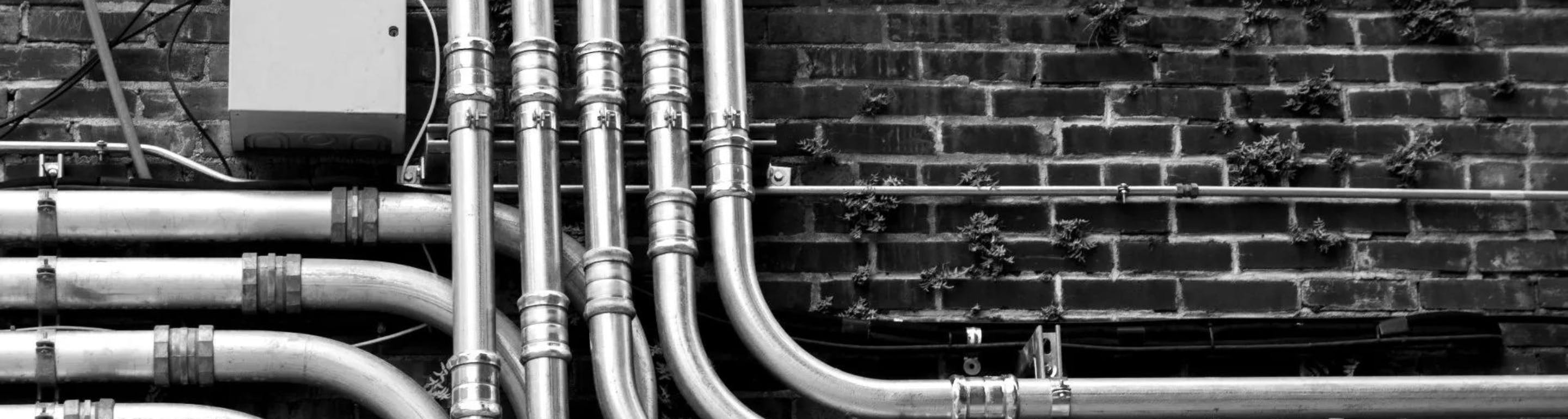 pipes against a brick wall