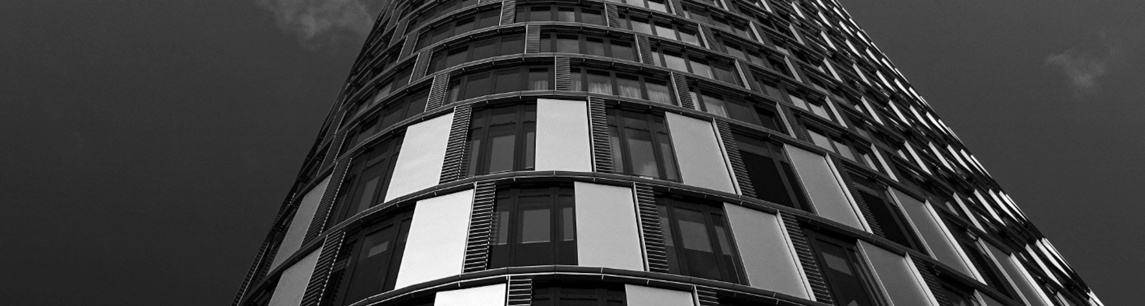 curved building with windows and alternating facade