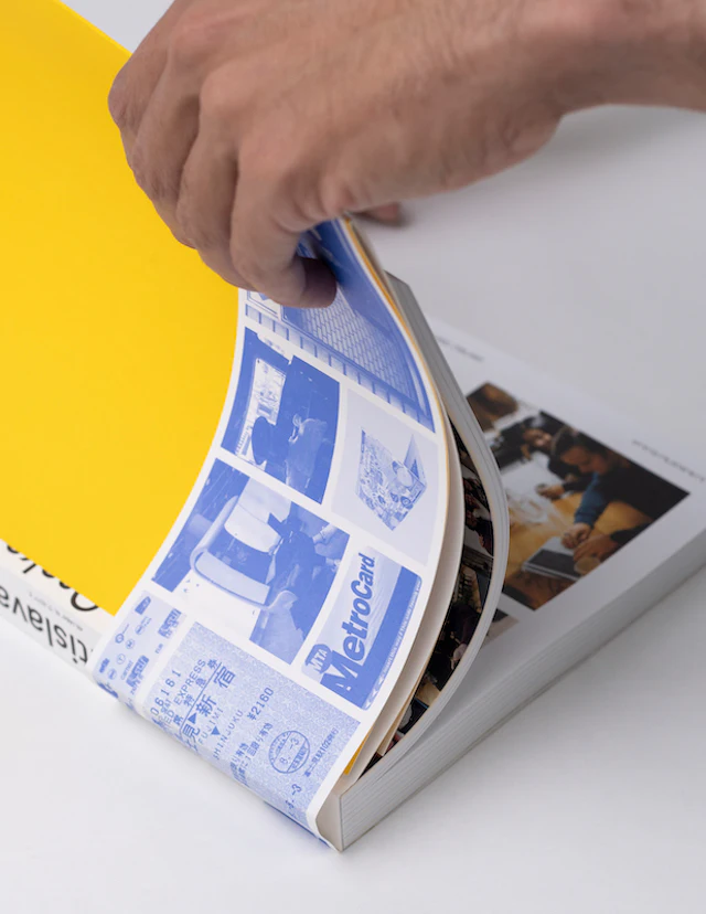 Hand flipping through pages showcasing the blue and white interior